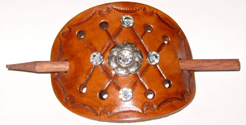 Oval barrette with silver floral concho and synthetic crystal rivets